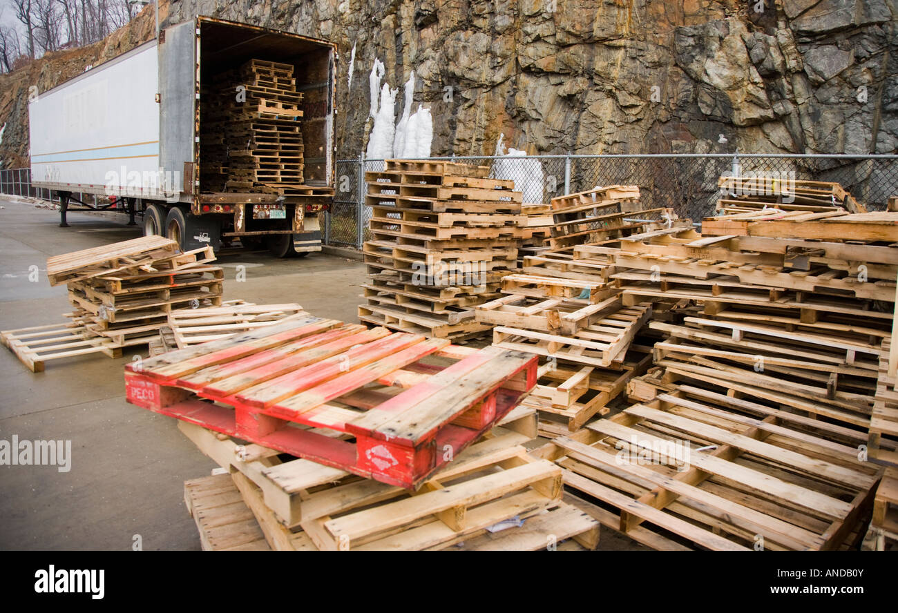 Empty wooden pallets behind a trailer Stock Photo