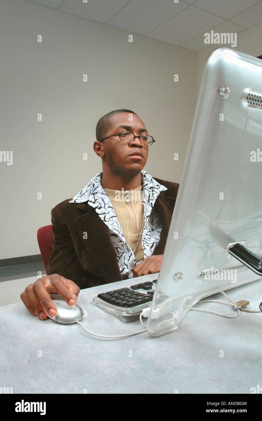 Black African American artist or art student working or browsing the Internet on a MacIntosh computer Stock Photo