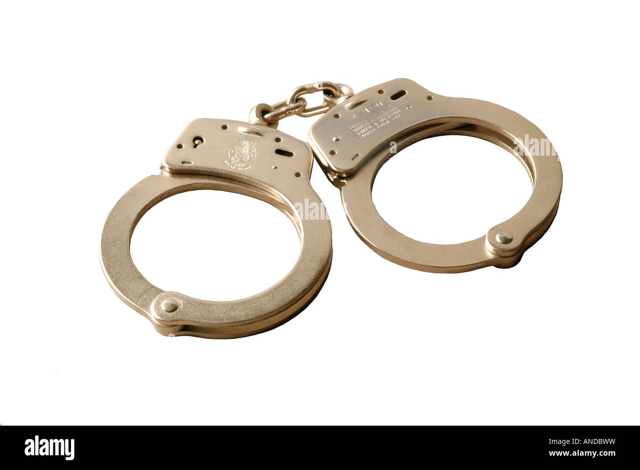 A pair of police handcuffs against white background Stock Photo