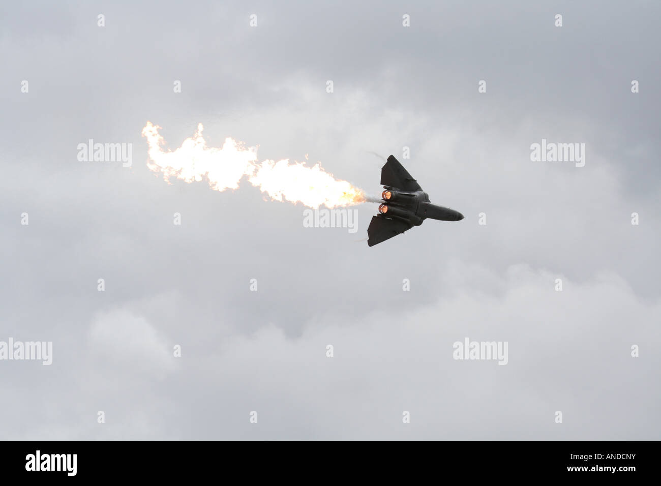 RAAF F-111 displaying at an airshow and doing a dump and burn, discharging fuel which is set alight by its engine afterburners Stock Photo