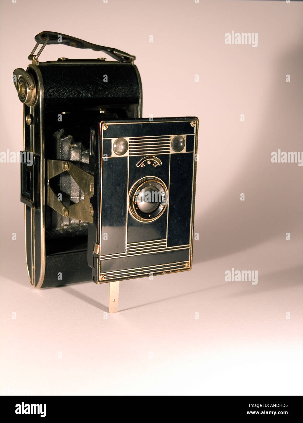 Old folder camera i sepia on a white background Stock Photo - Alamy