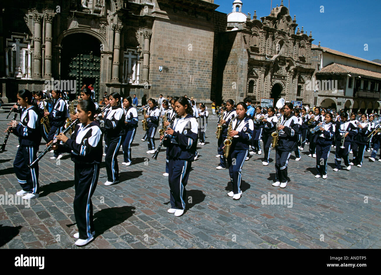 Girls in marching band outside La Compania de Jesus Church and Cusco University, Plaza de Armas, Cusco, Peru Stock Photo