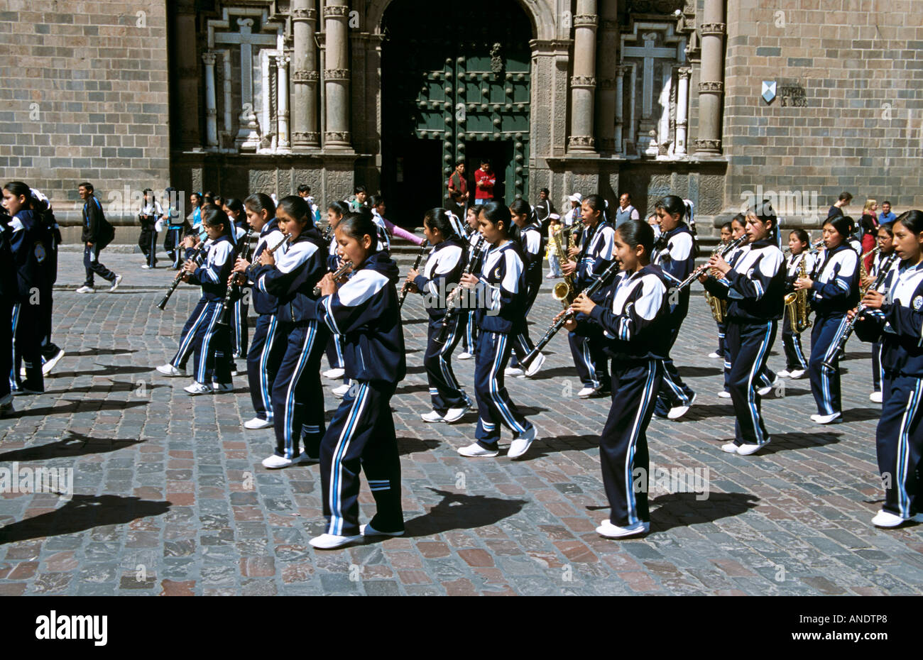 Girls in marching band outside La Compania de Jesus Church, Plaza de Armas, Cusco, Peru Stock Photo