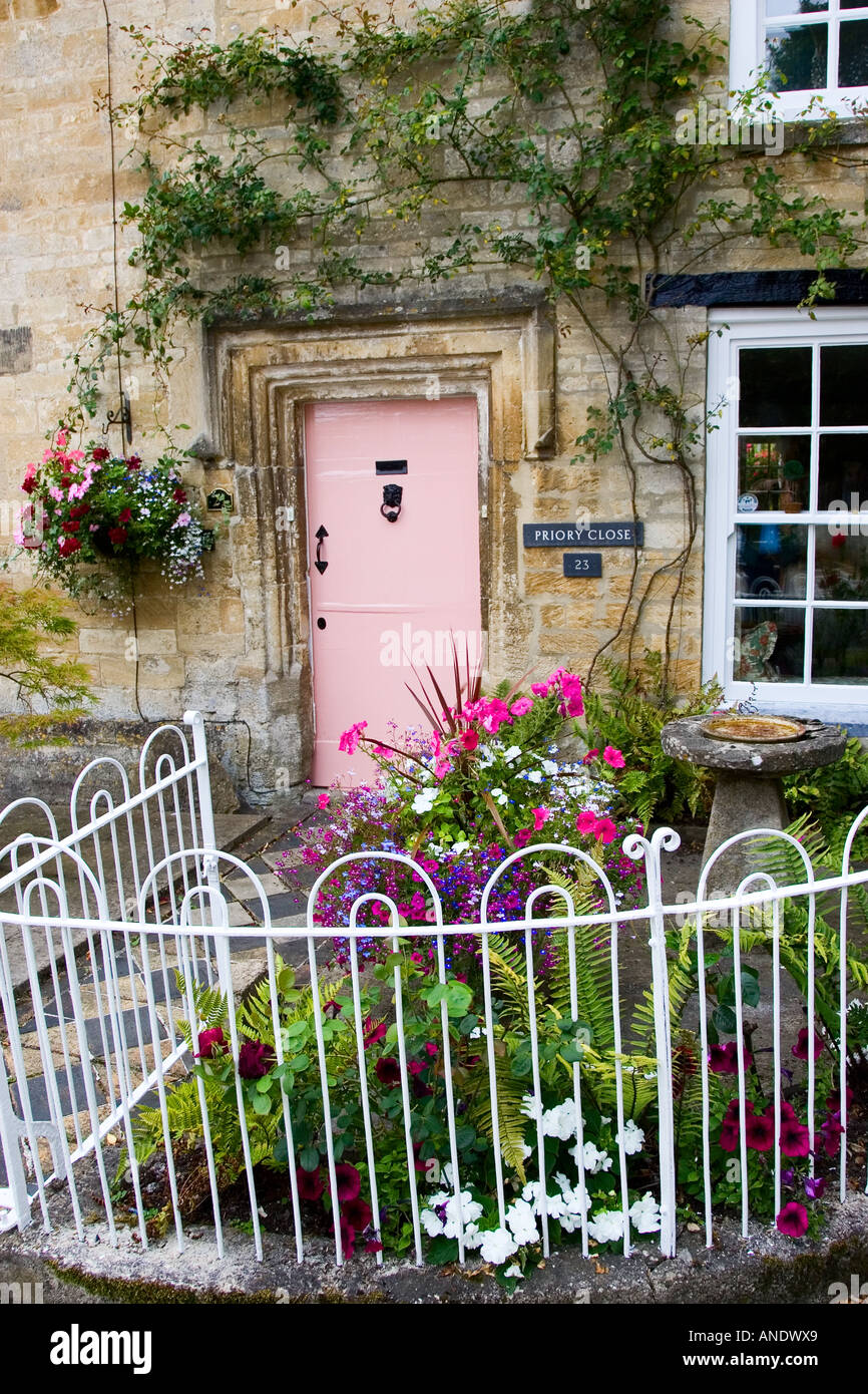 Cotswolds cottage and fenced front garden Burford Oxfordshire UK Stock Photo