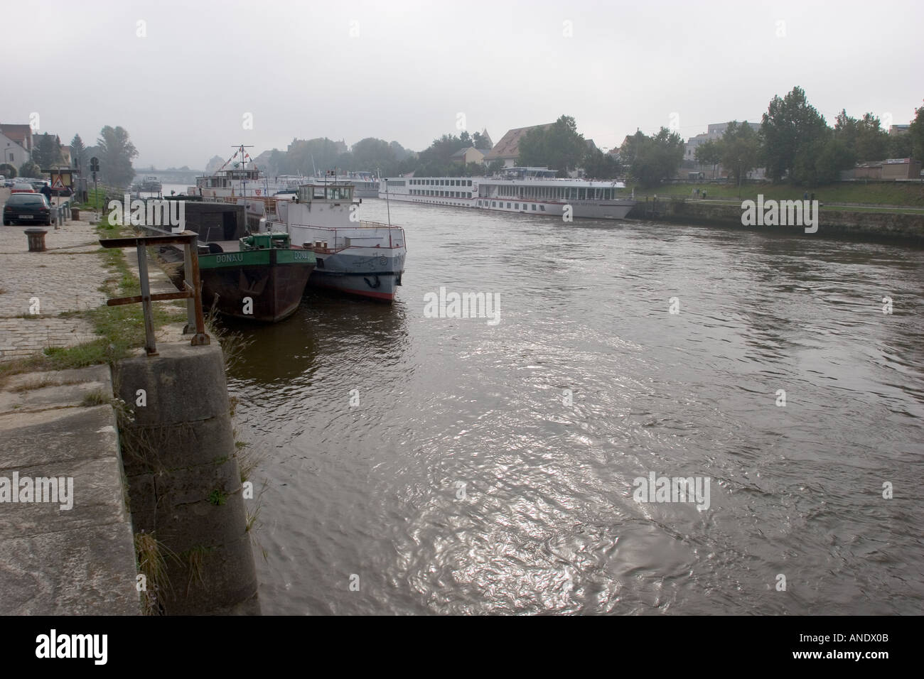 Working boats on at the ancient city of Regensburg on the Danube River Germany Western Europe Stock Photo