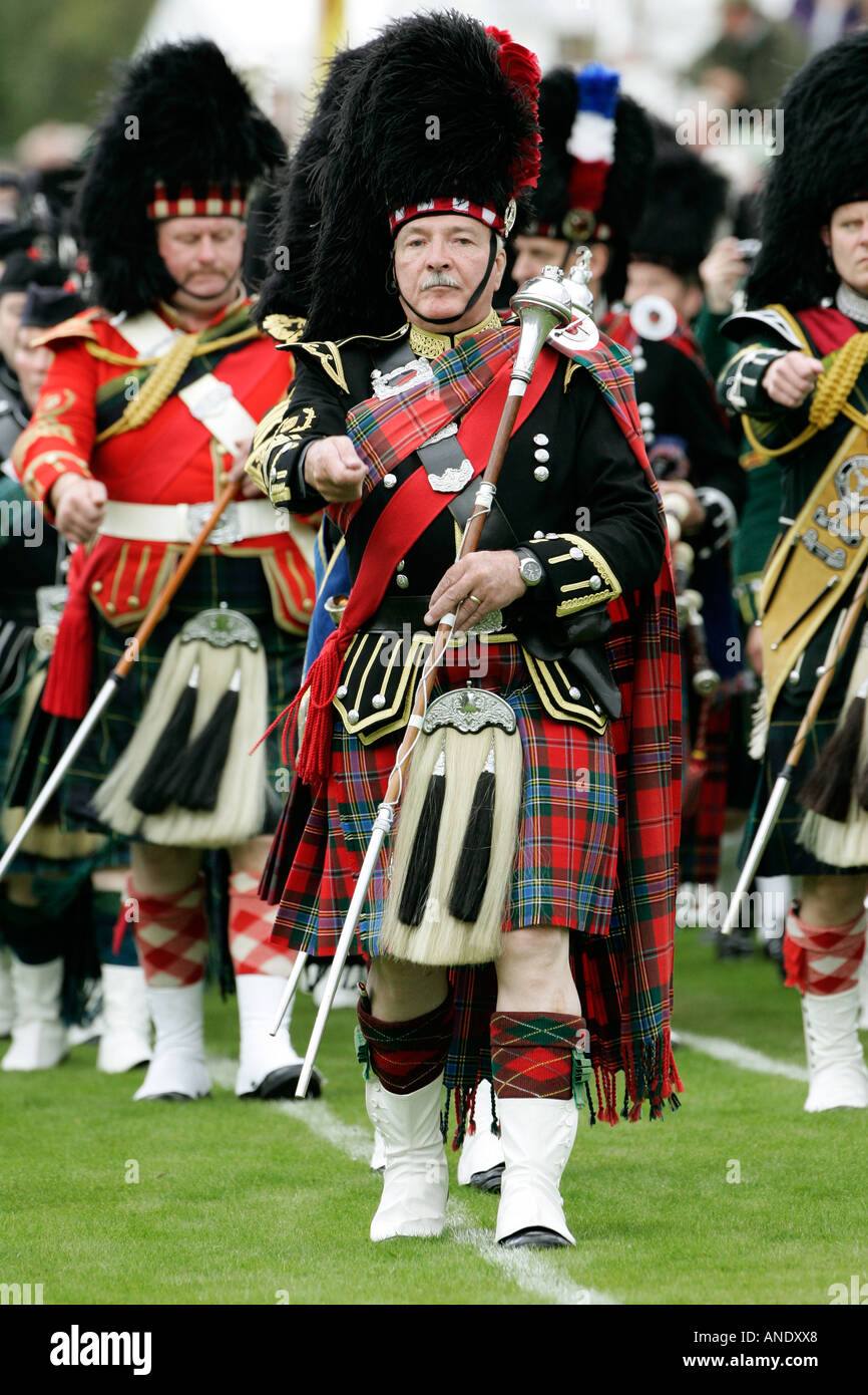 Drum Major leads massed band of Scottish pipers at Braemar Games Highland Gathering Stock Photo