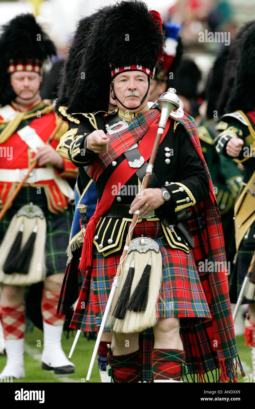 Drum Major leads massed band of Scottish pipers at the Braemar Games Highland Gathering Stock Photo