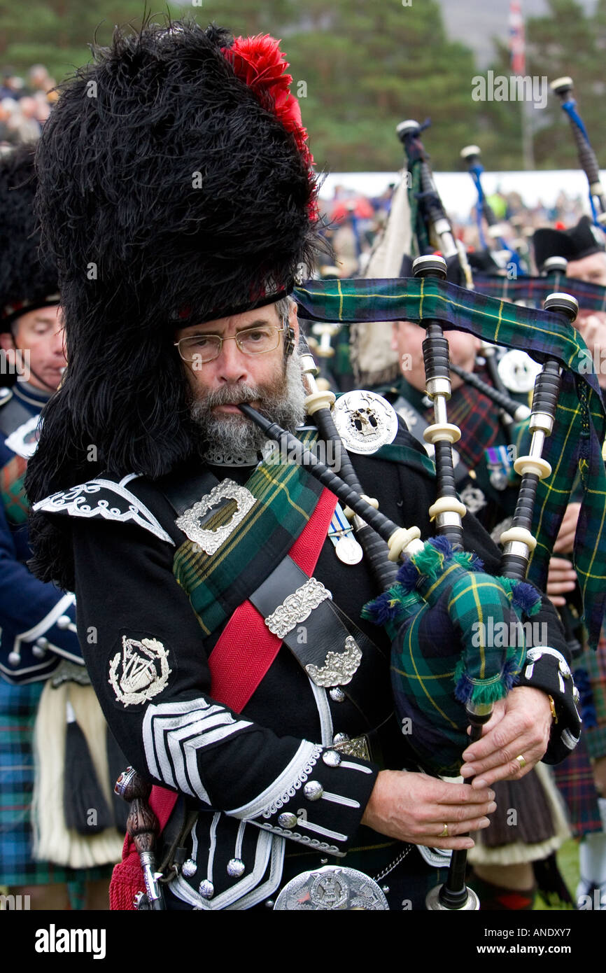 Bagpipe player of massed band of Scottish pipers at Braemar Games Highland Gathering Scotland Stock Photo