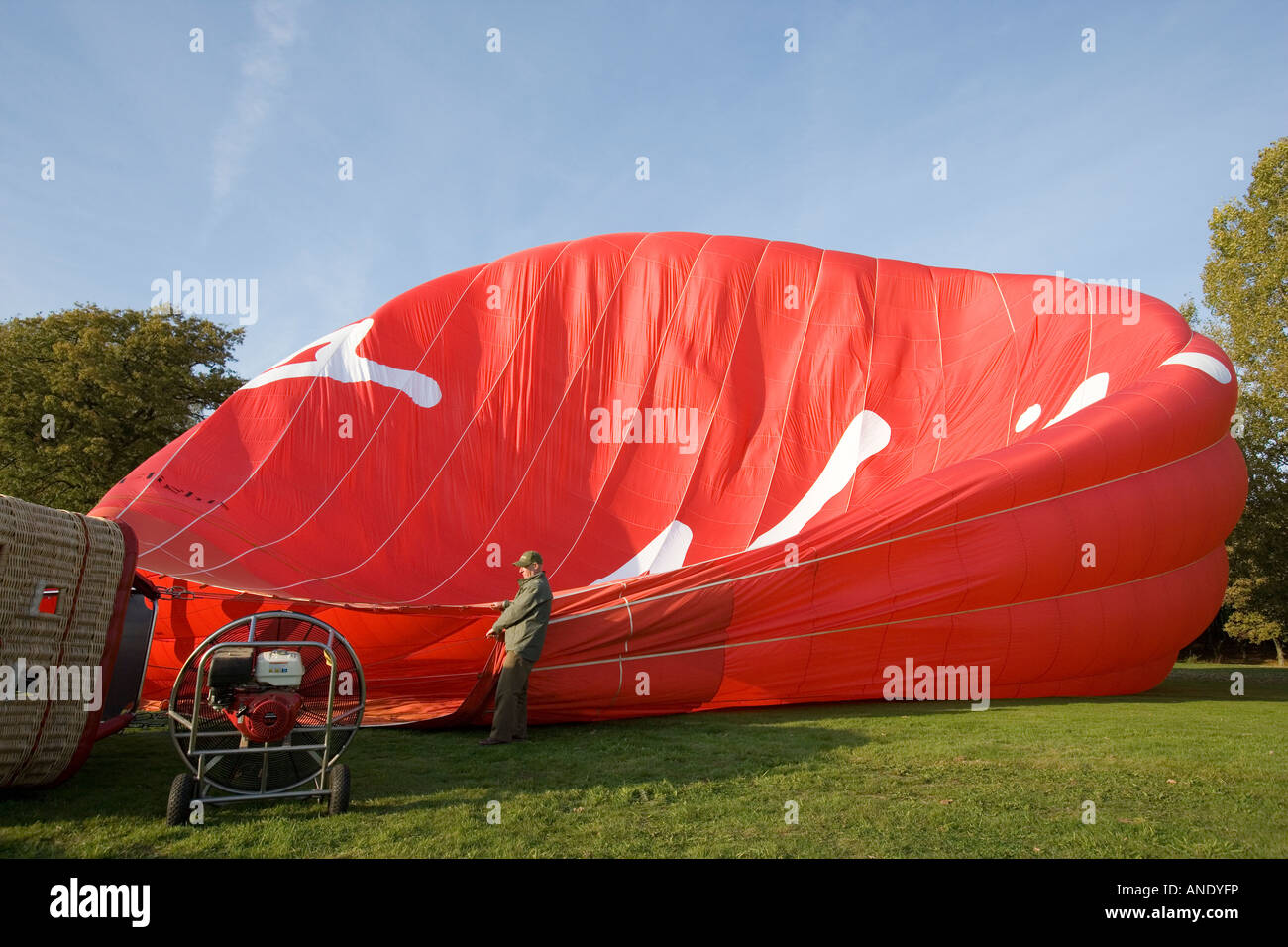 hot air ballon onboard red material basket blue sky looking up travel adventure tourism flight flying fun Stock Photo