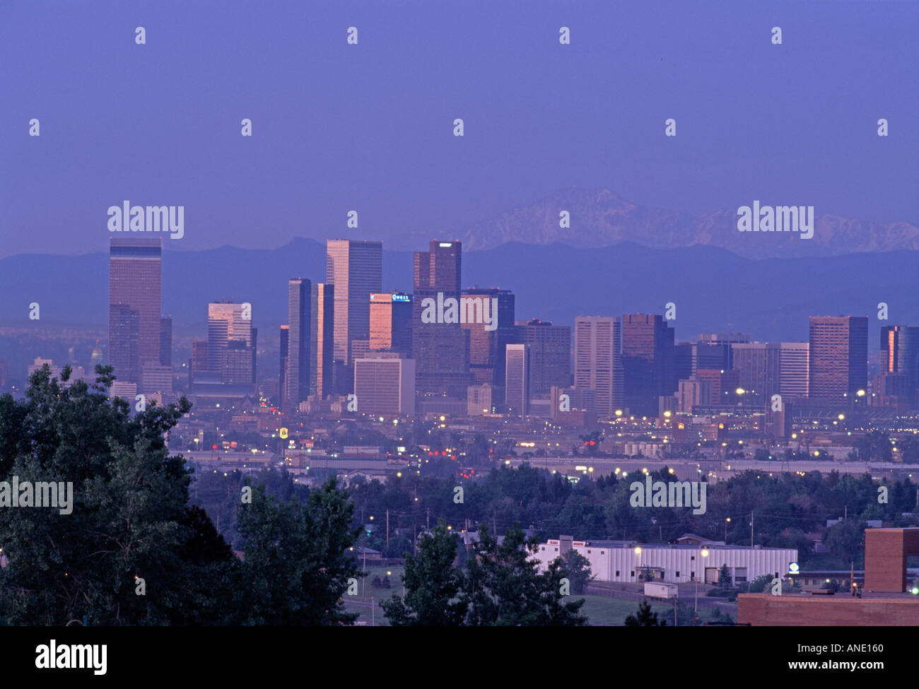 A spring dawn view of Denver s skyline with Pike s Peak in the background Denver CO Stock Photo