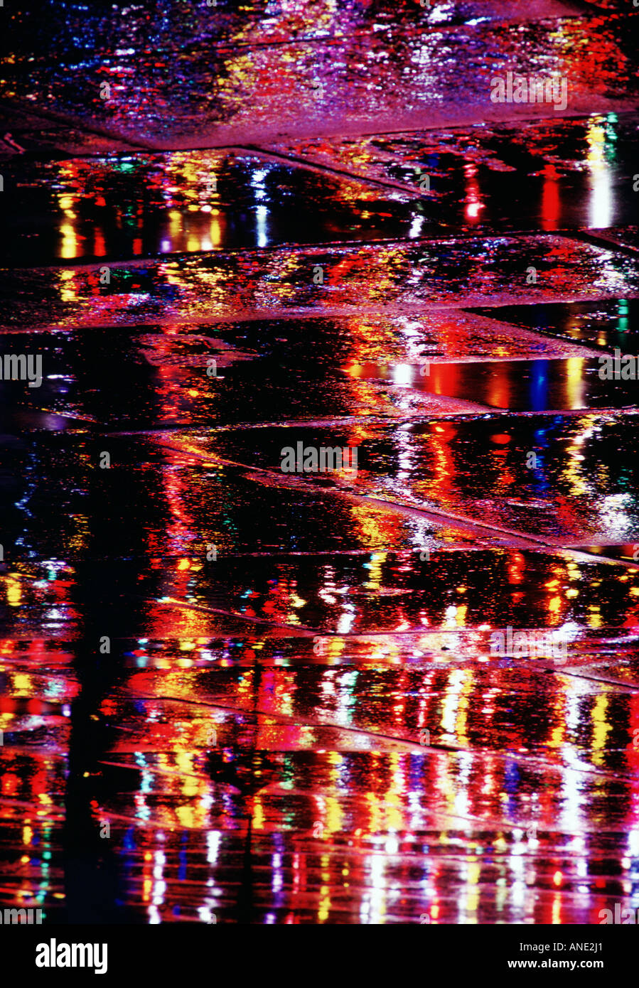 City lights reflecting on wet paving stones Trafalgar Square London United Kingdom Stock Photo