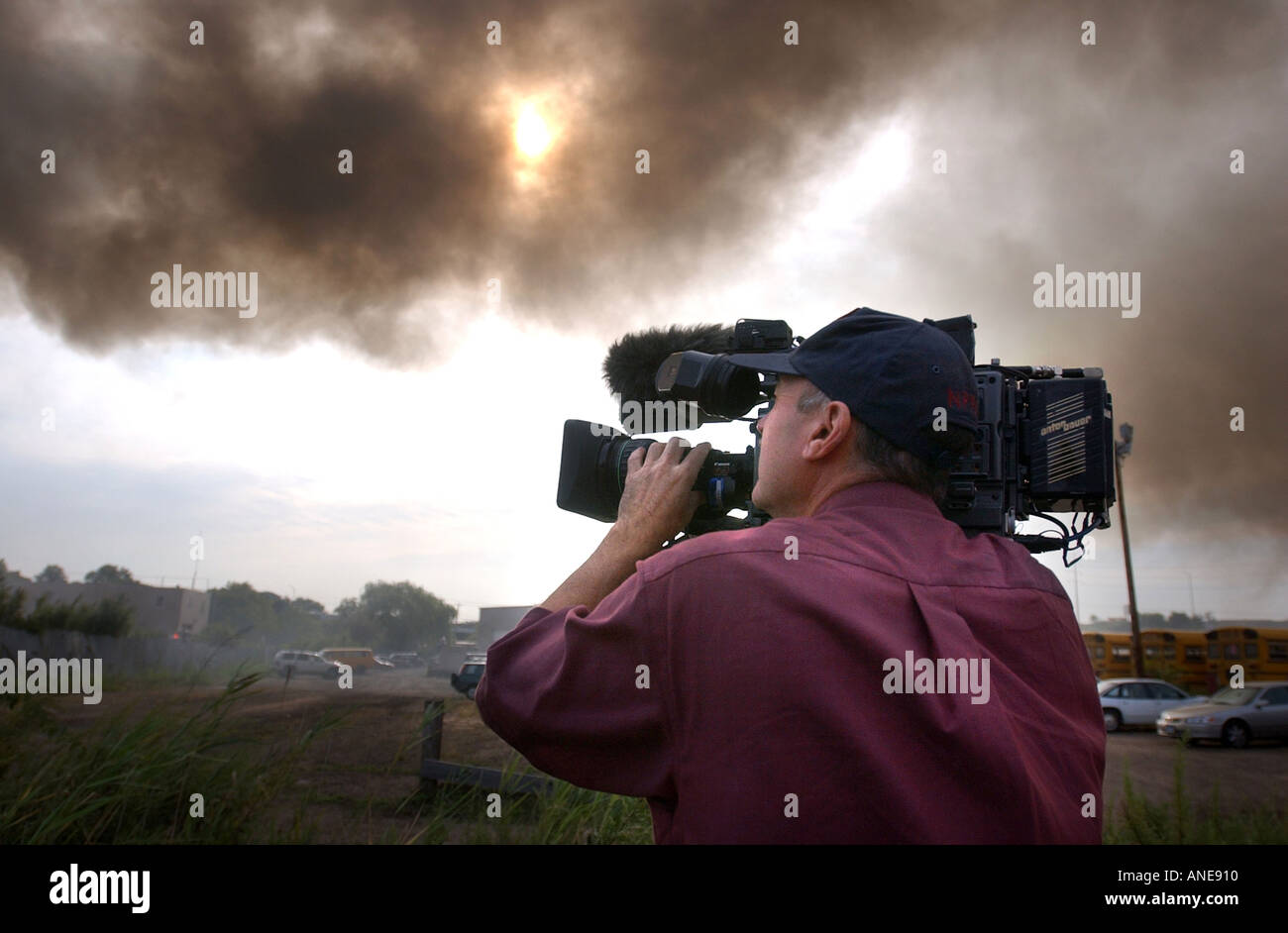 Television cameraman photographer filming fire and smoke Stock Photo