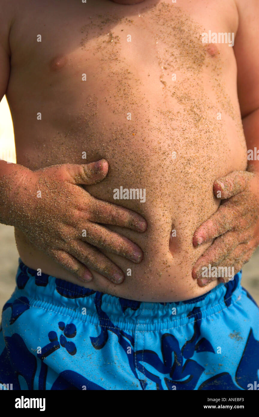 sandy stomach and hands Stock Photo