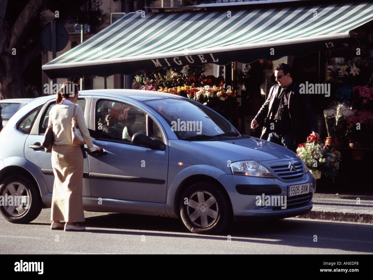 Spain Malaga flower shop Citroen car and shoppers outside Stock Photo