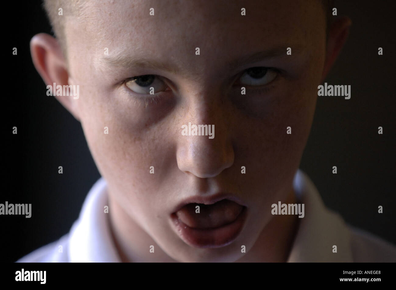 caucasian negative sinister evil mad crazy intense teenage boy twelve portrait threatening dissaffected youth male  Stock Photo