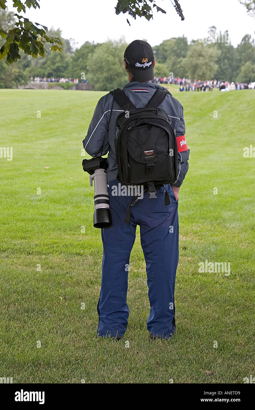 Photographer with long zoom lens on golf course, adare, Ireland. Stock Photo