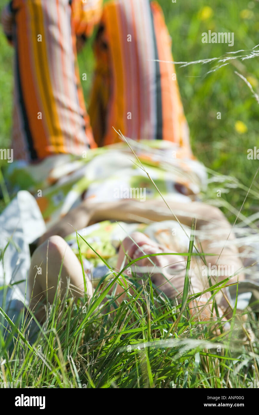 Young woman reclining in tall grass with knees up Stock Photo Alamy