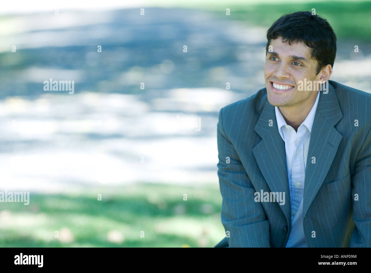 Businessman in park, smiling Stock Photo