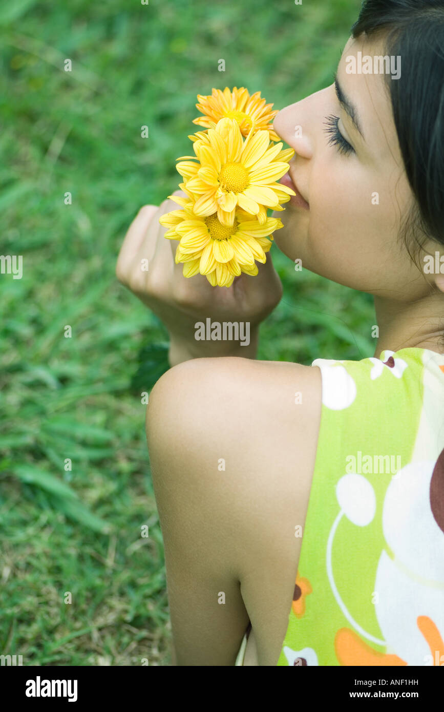 Young woman smelling flowers, close-up Stock Photo