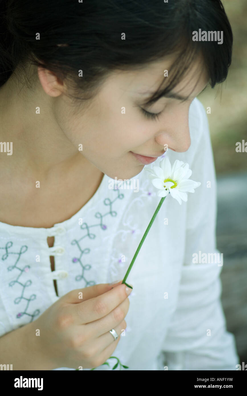 Woman smelling flower, close-up Stock Photo