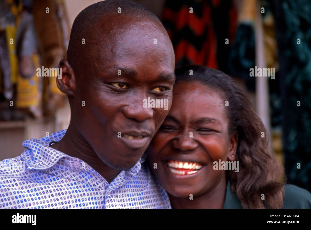 Portrait of smiling young black African man & woman posing together in outdoor location Jinja City Uganda East Africa Stock Photo