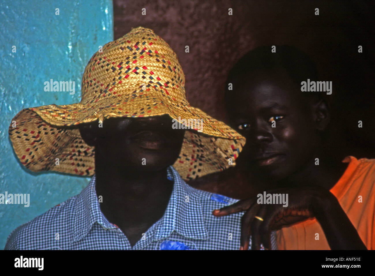 Pair of black boys posing together & playing with camera one with a straw hat over his head Kigali Rwanda East Africa Stock Photo