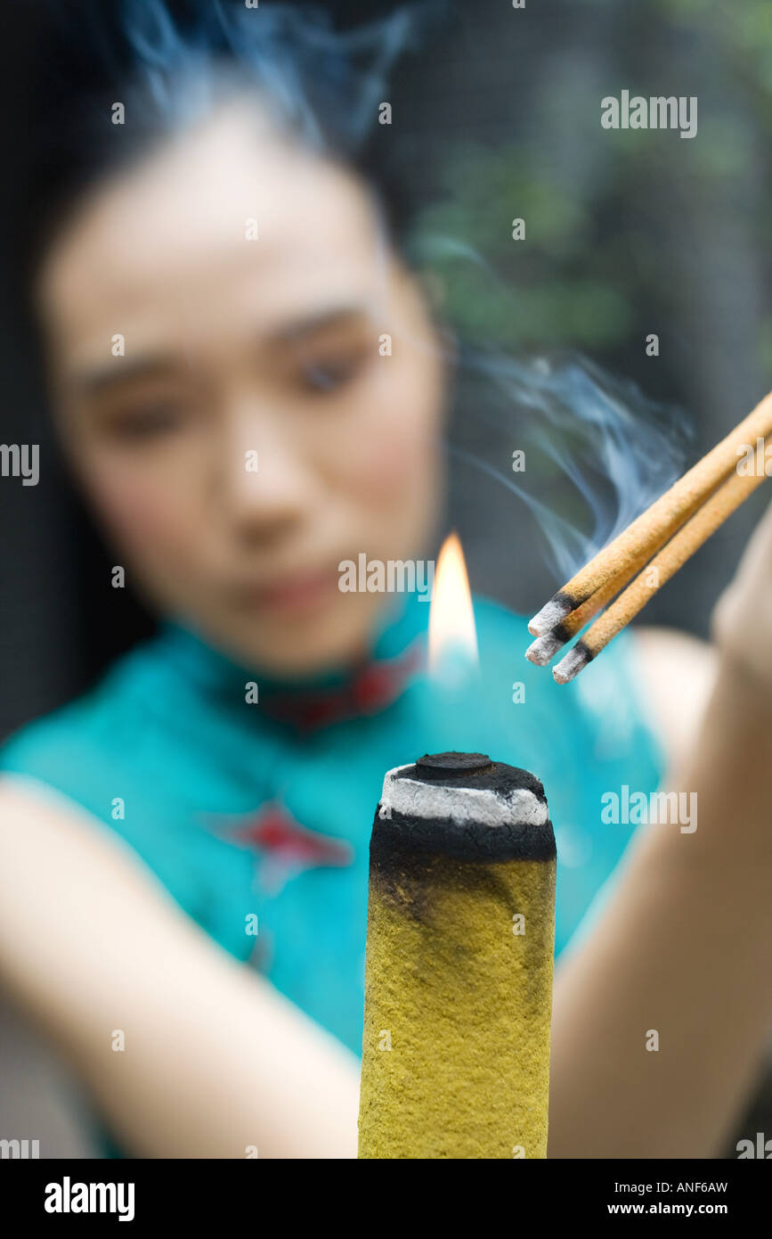 Young chinese woman burning incense hi-res stock photography and images ...