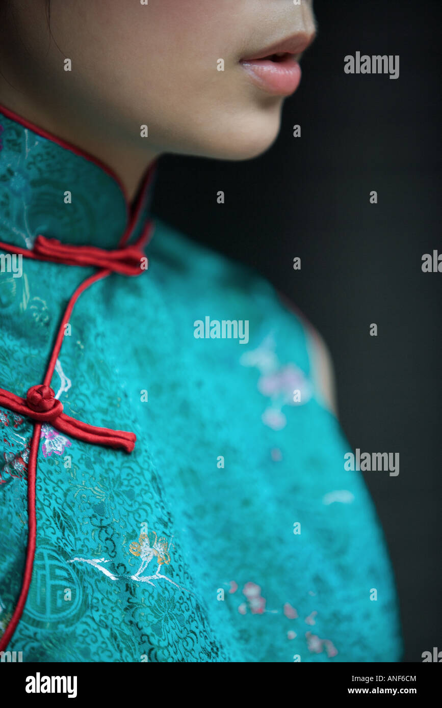 Young woman dressed in traditional Chinese clothing, cropped view of lower face and bust Stock