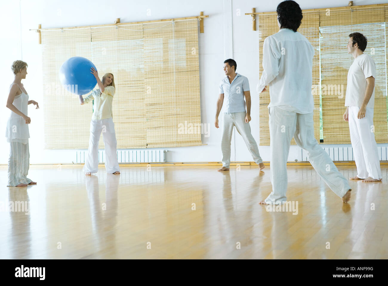 Five adults standing in circle, throwing ball Stock Photo Alamy