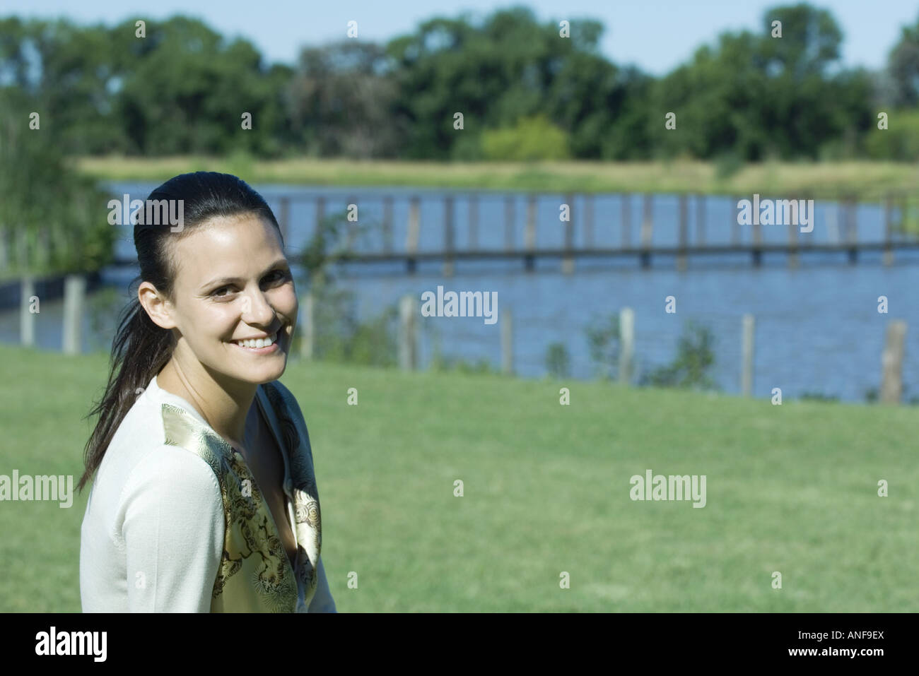 Young woman in park, smiling at camera Stock Photo - Alamy