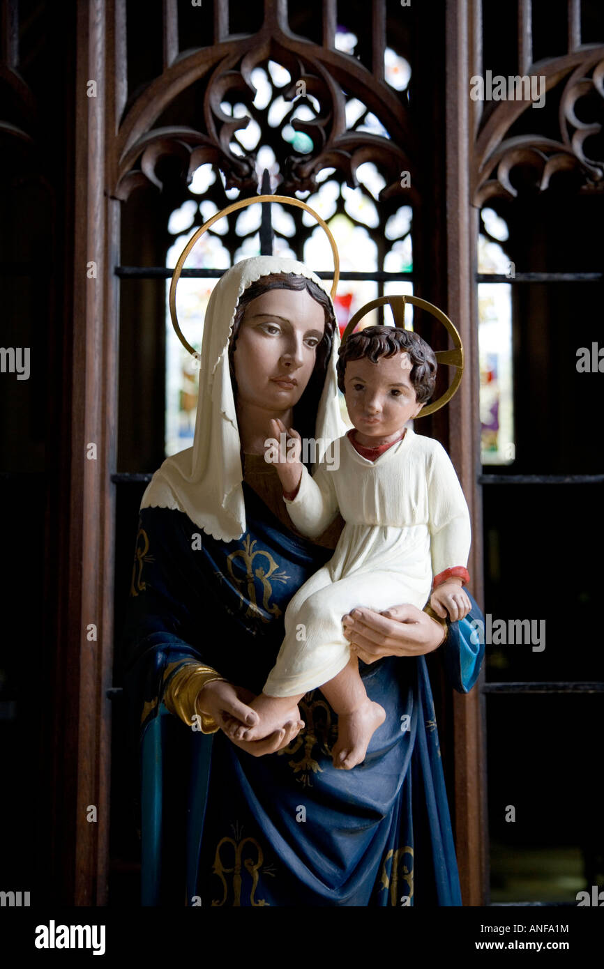 A statue of Jesus Christ as a child held by his mother Mary within ...