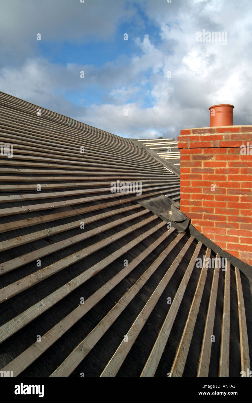 Detached house under construction roof works including felt battens and general preparation for plain tiles zox Stock Photo