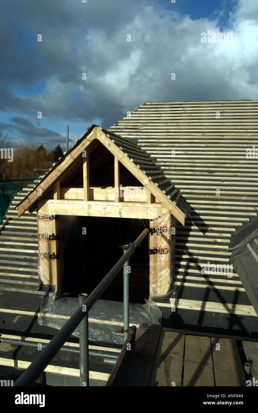 Detached house under construction roof works including gable end felt battens and general preparation for plain tiles  zox Stock Photo