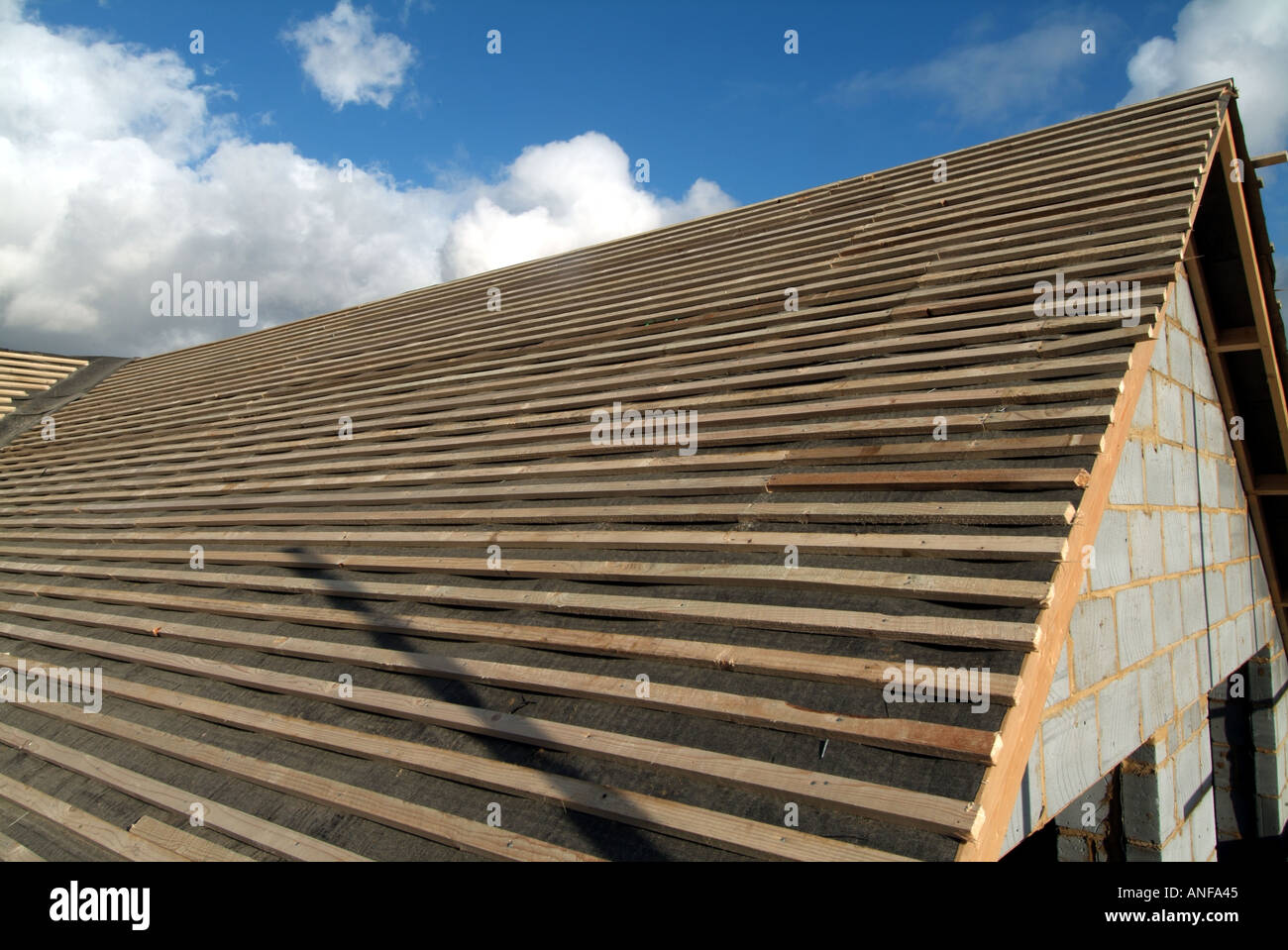 Detached house under construction roof works including gable end felt battens and general preparation for plain tiles  zox Stock Photo