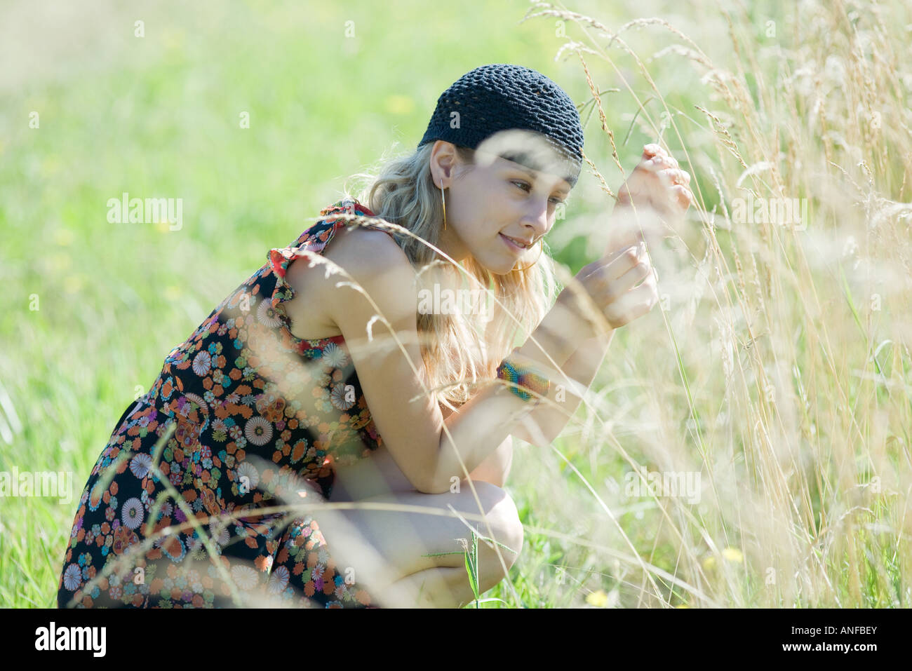 Portrait of woman touching grass Stock Photo - Alamy