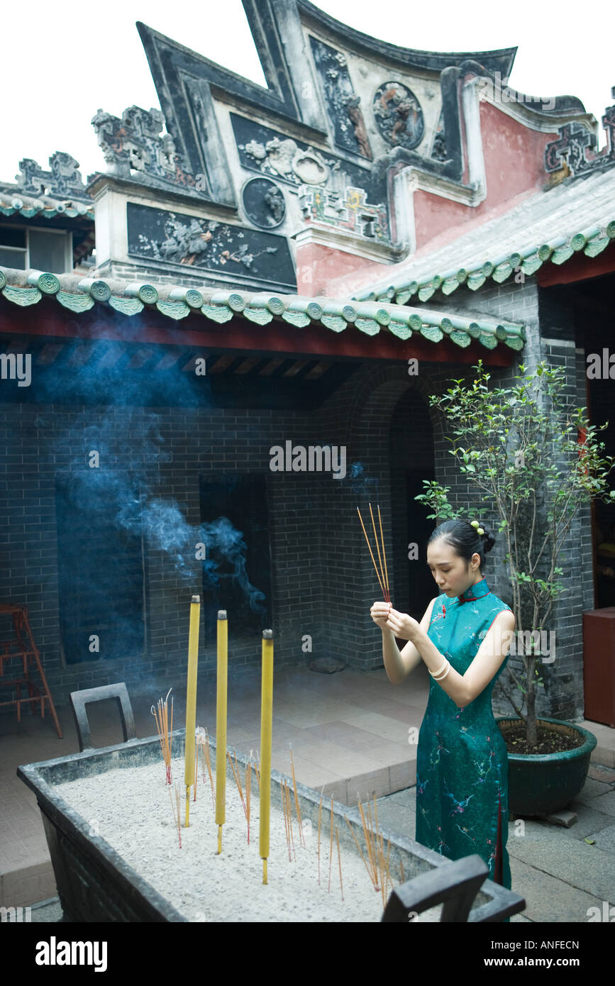 Woman praying in front incense hi-res stock photography and images - Alamy