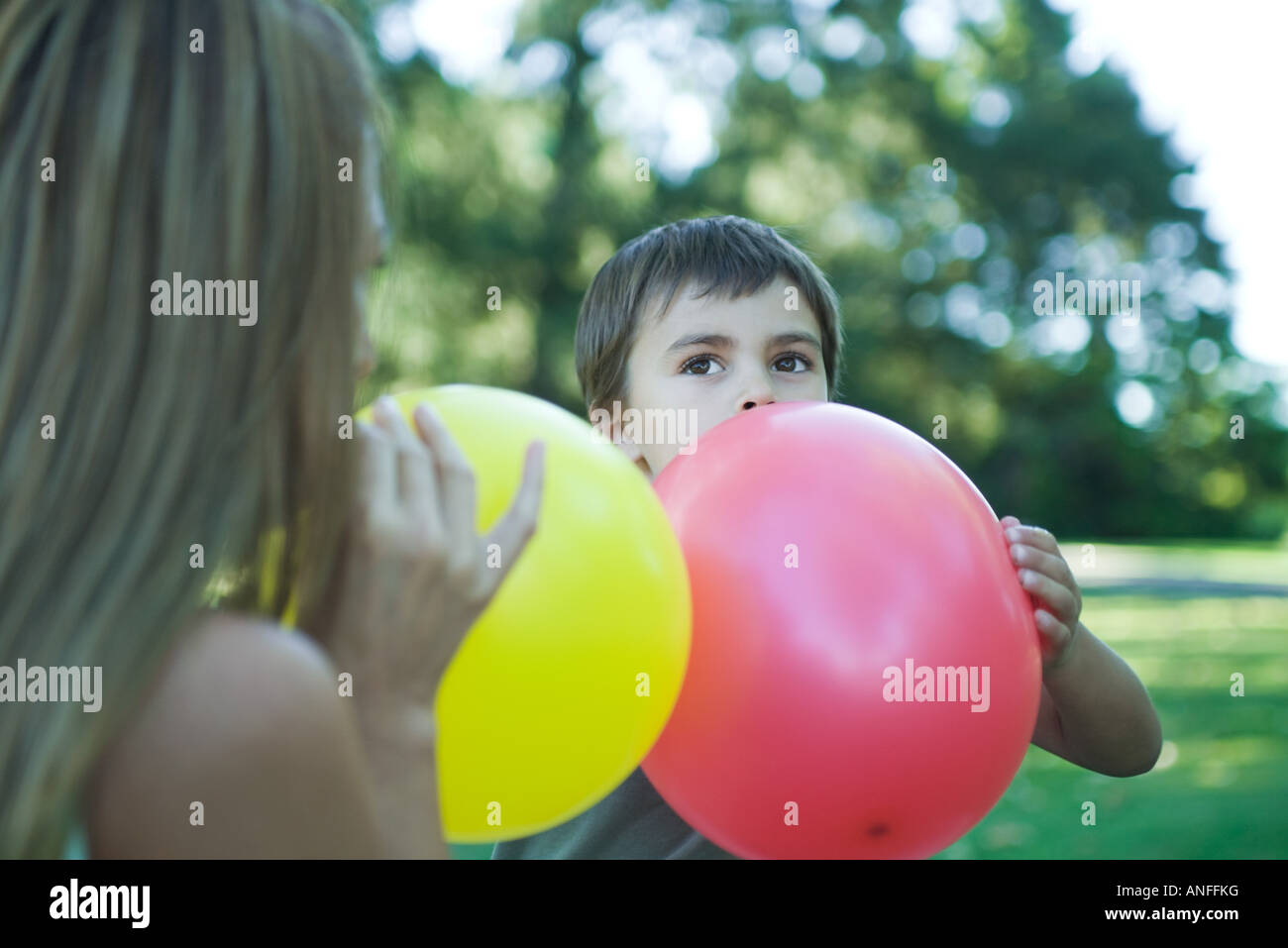 Boy and mother blowing up balloons Stock Photo Alamy