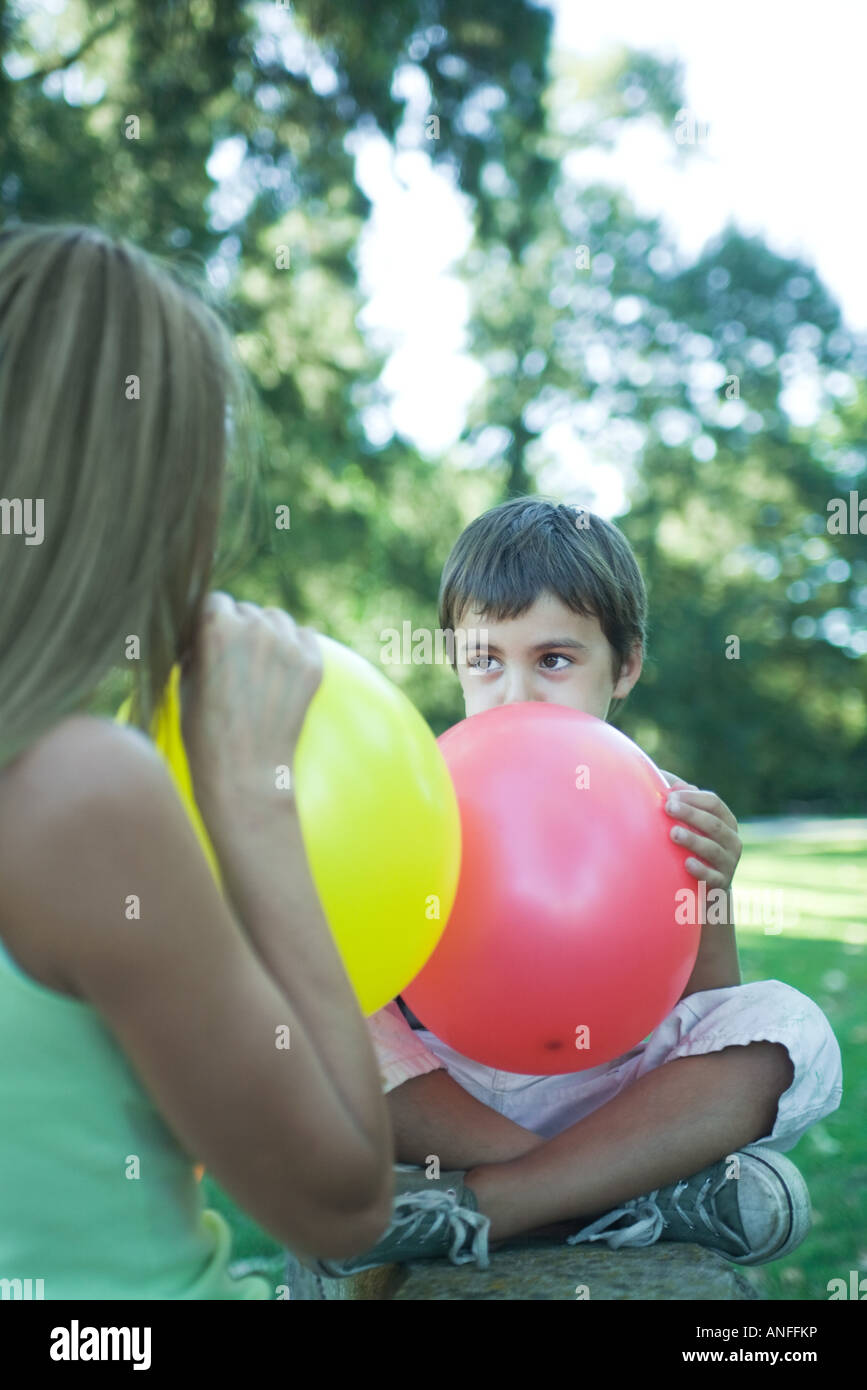 Boy and mother blowing up balloons Stock Photo Alamy