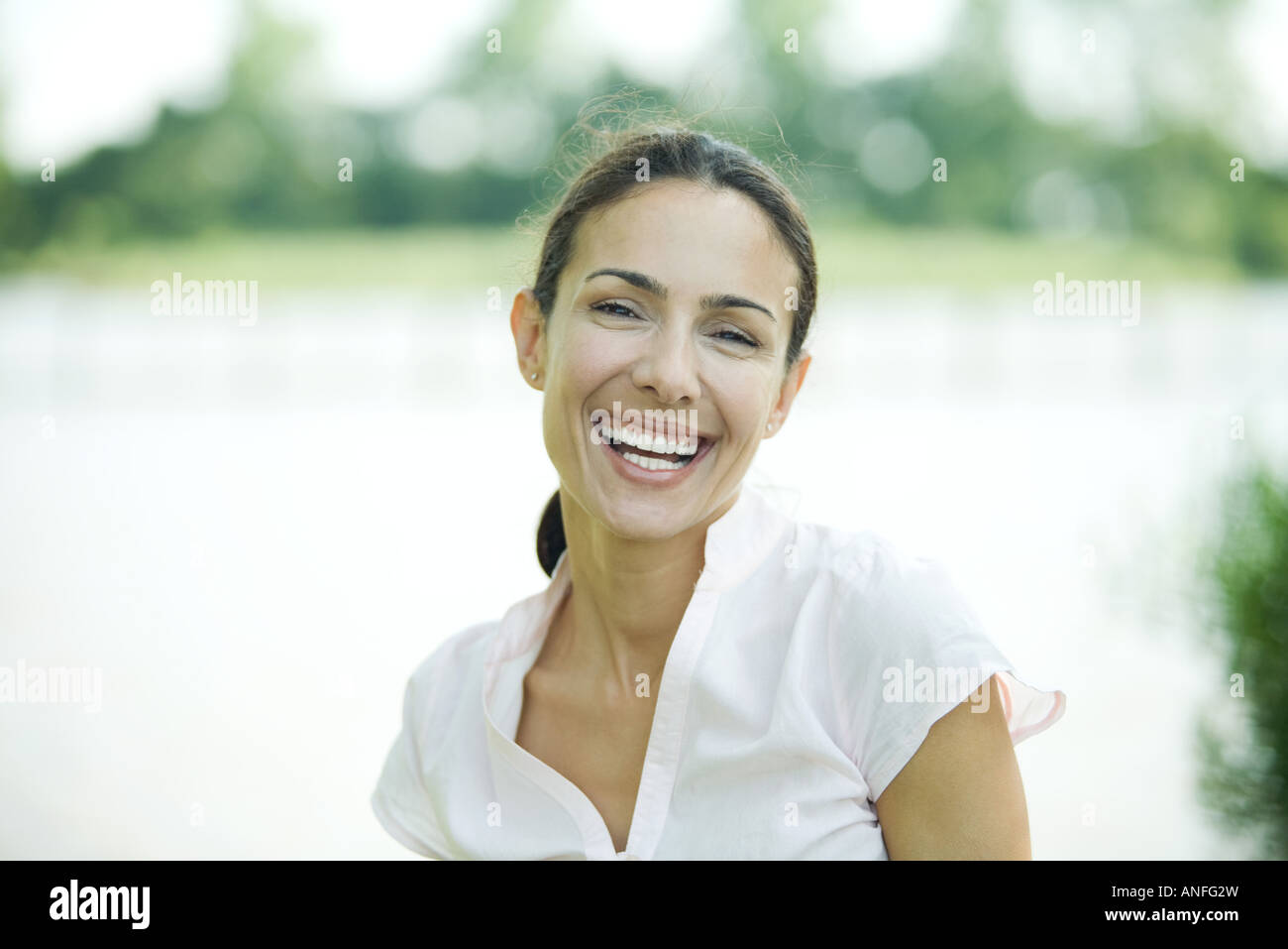 Woman outdoors, smiling at camera, head and shoulders Stock Photo - Alamy