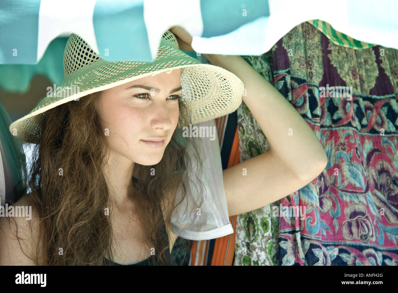 Young woman wearing straw hat, looking away Stock Photo