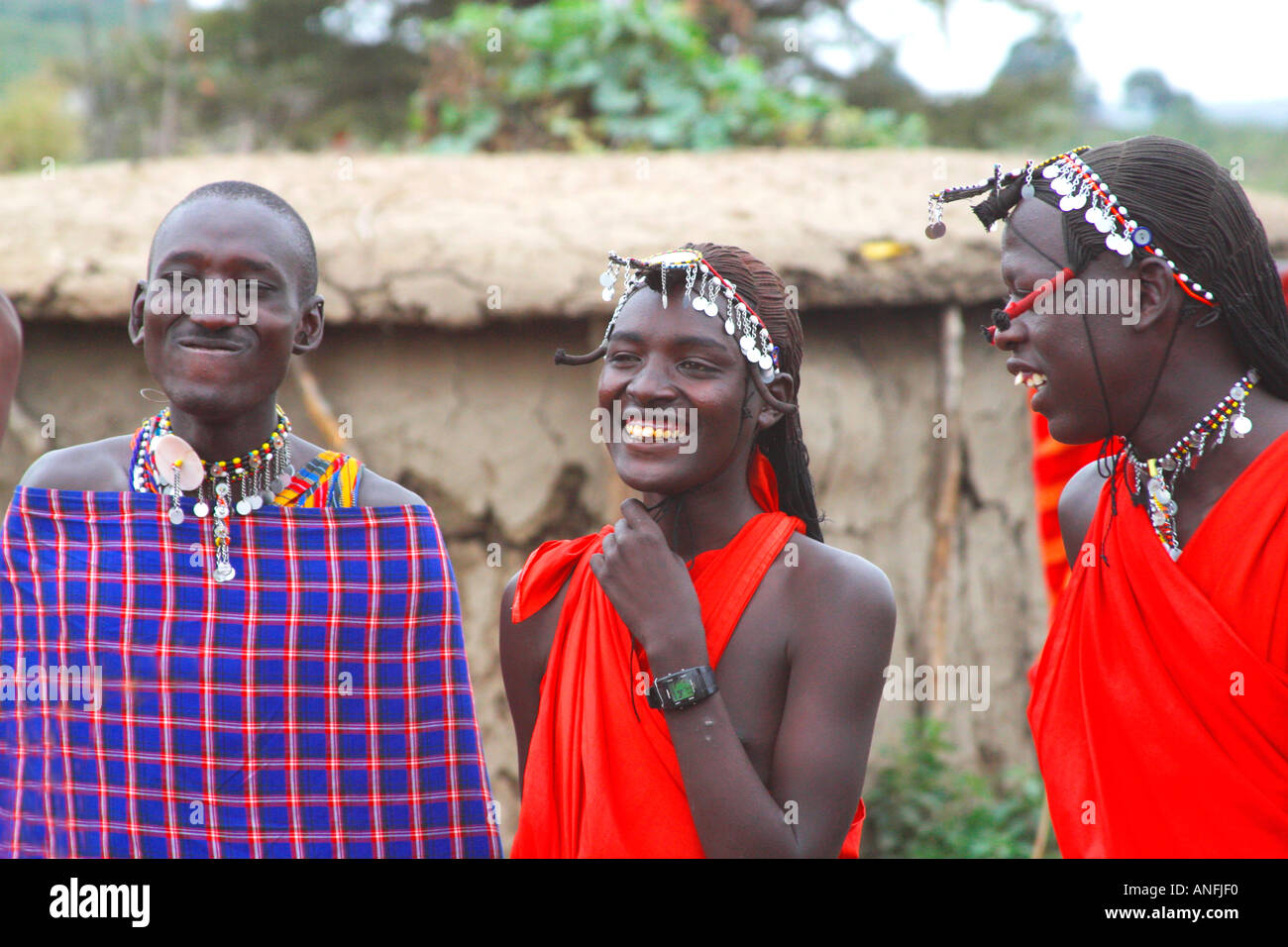 Maasai warriors wear traditional red blankets in the Masai Mara Kenya East Africa Stock Photo