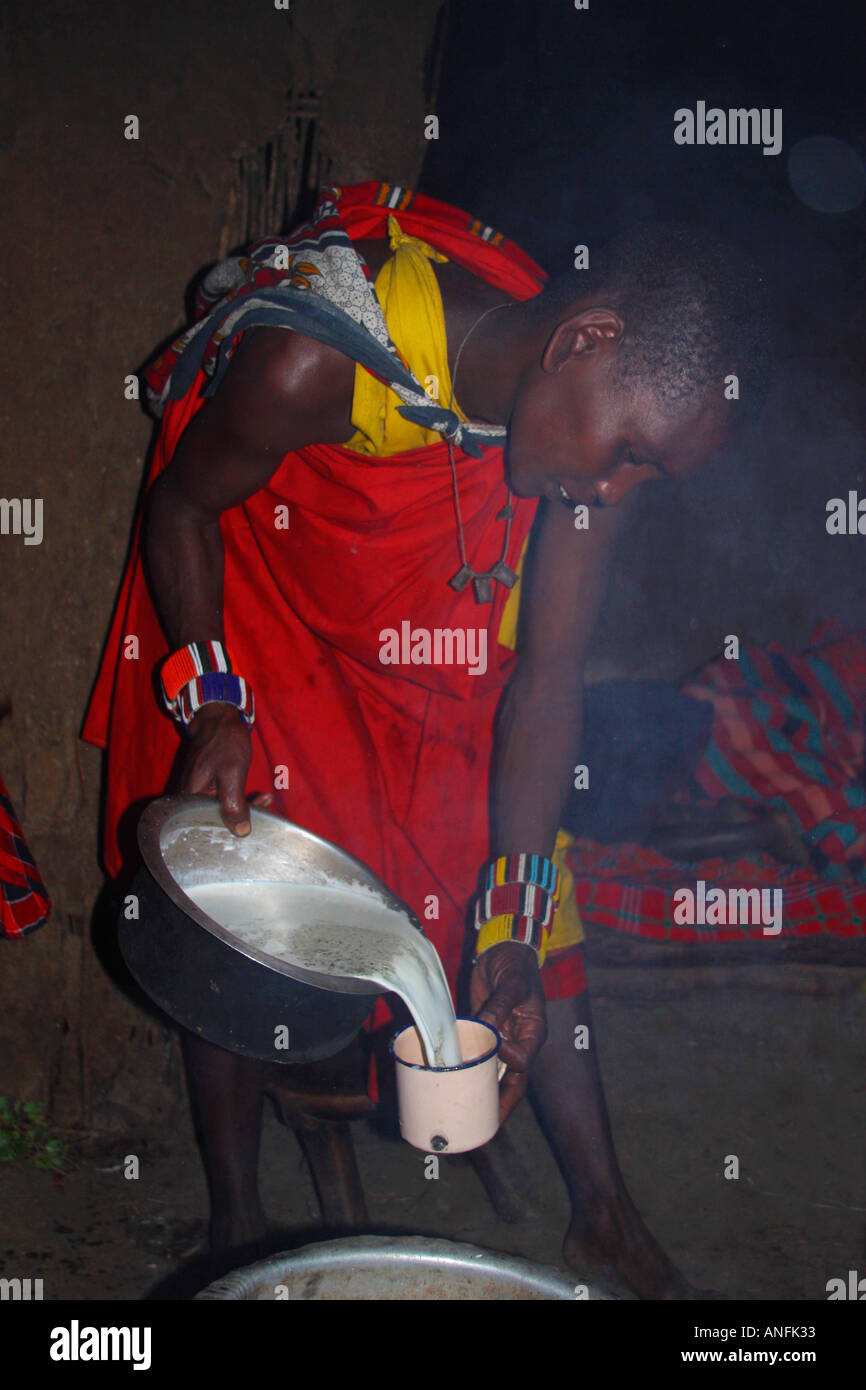 Maasai mother hut tribal village milk cows blood drink for her children Masai Mara Kenya East Africa Stock Photo