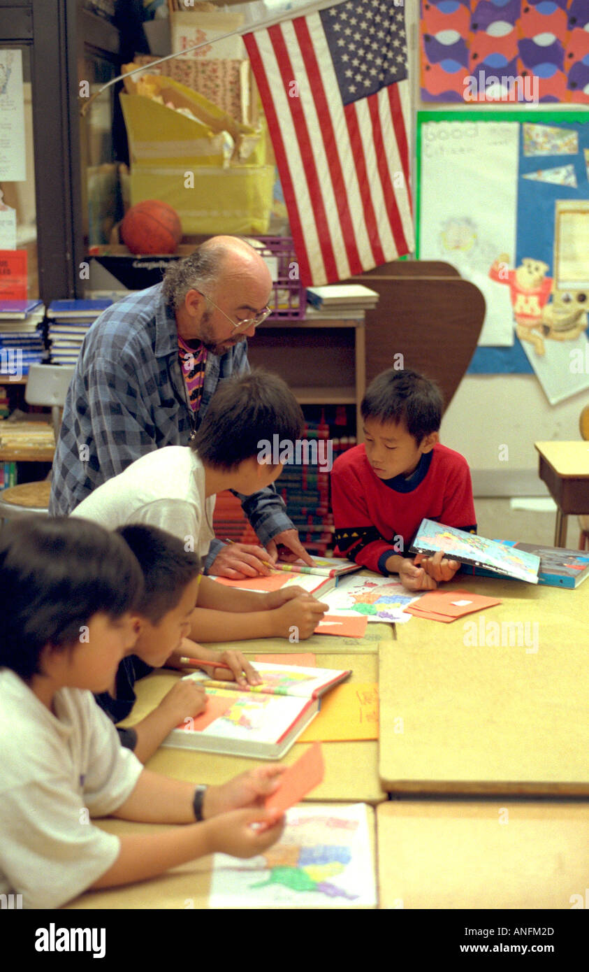 Geography class of Asian American 6th graders age 11 at summer school white teacher. Holland School Minneapolis Minnesota USA Stock Photo