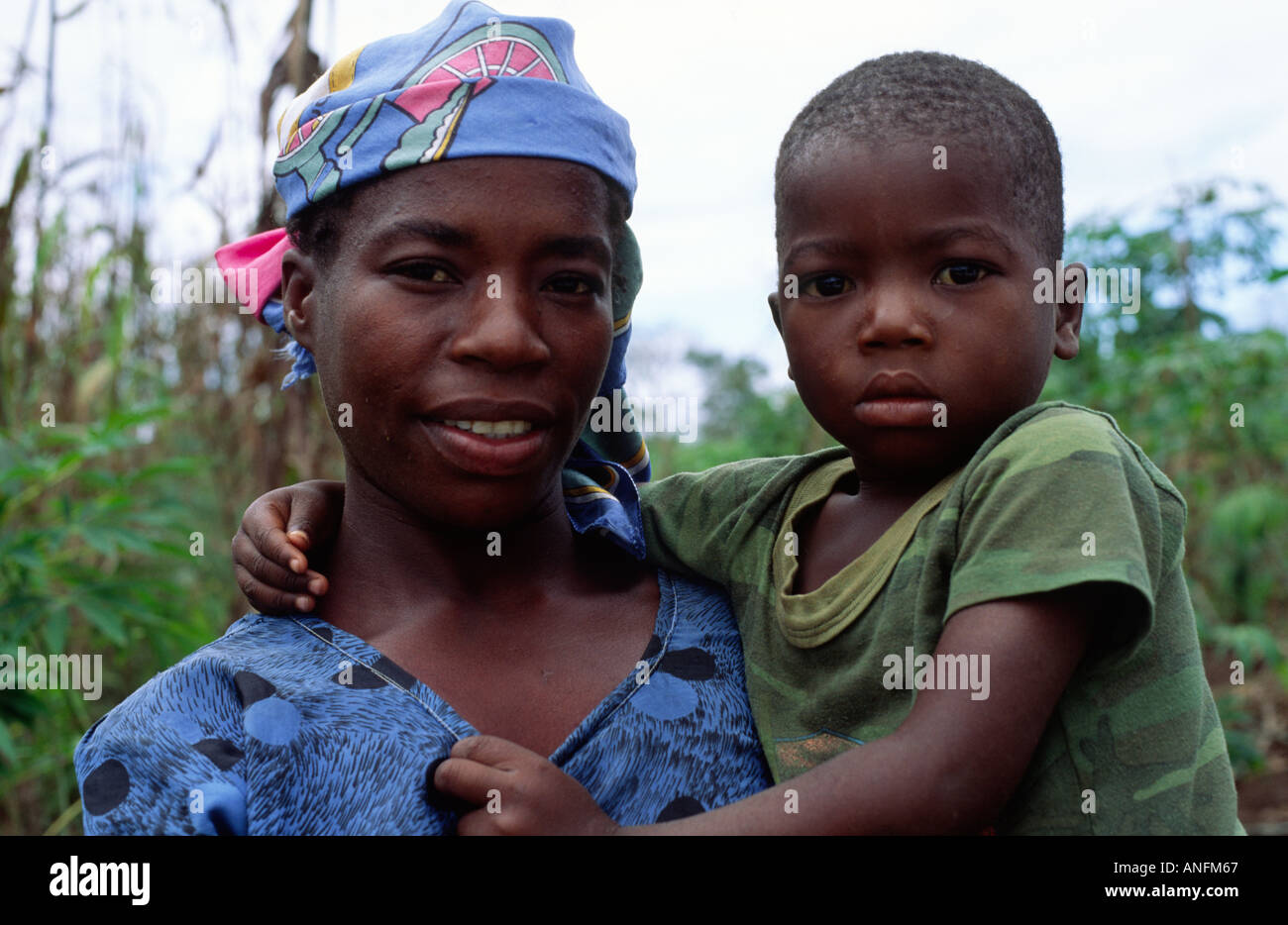 Landscape portrait of a poor mother and her child from a subsistence farming community in a remote rural part of Mozambique Stock Photo