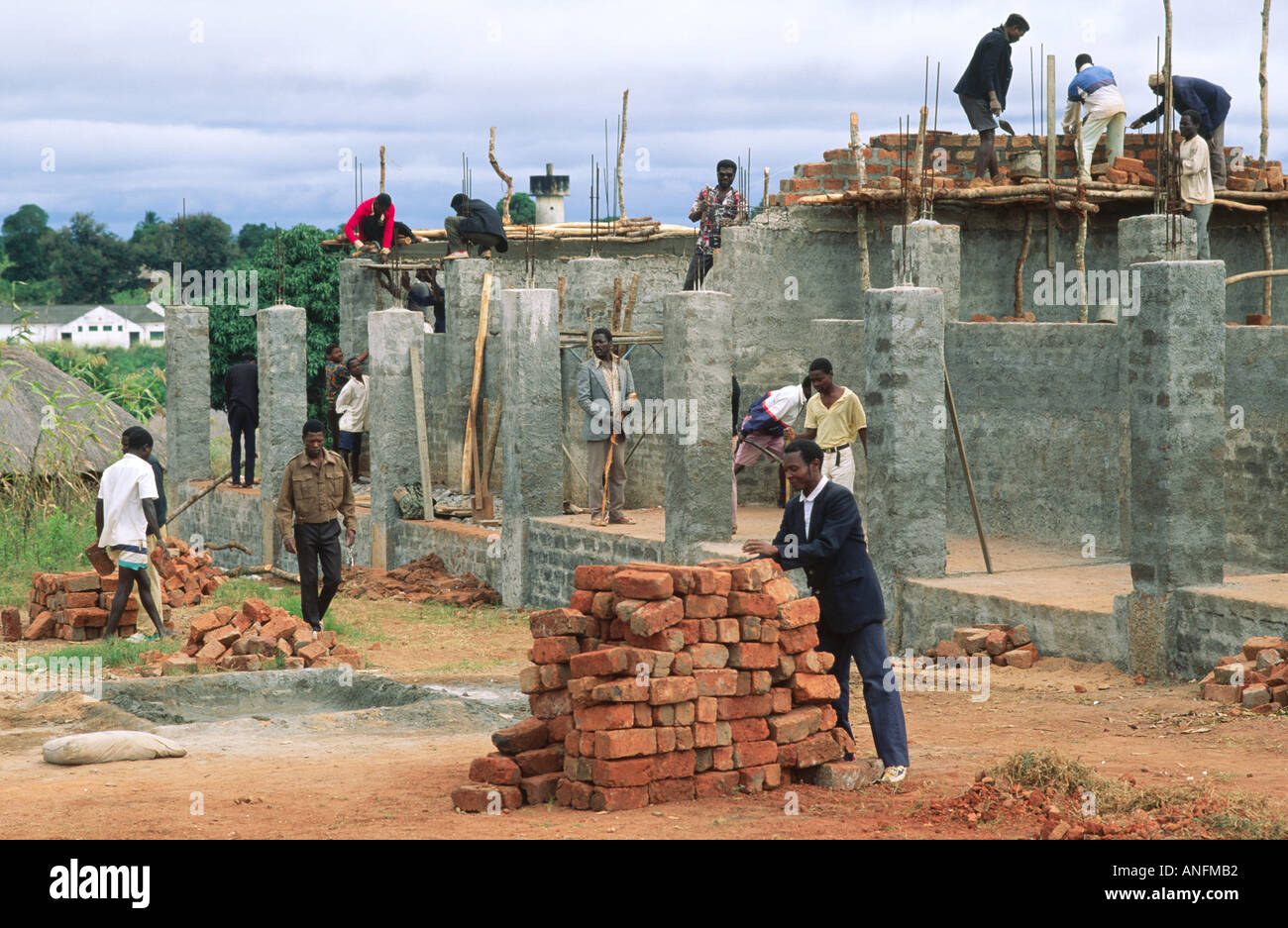 Community labourers reconstructing a rural school after it's destruction during the civil war. Zambezia,. Mozambique Stock Photo