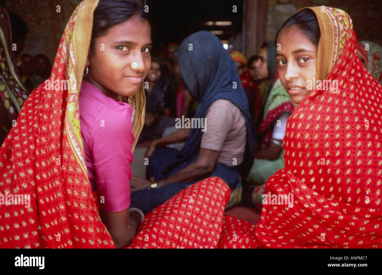 Two Gujarati girls looking to camera at a rural women's meeting. Gujarat, India Stock Photo