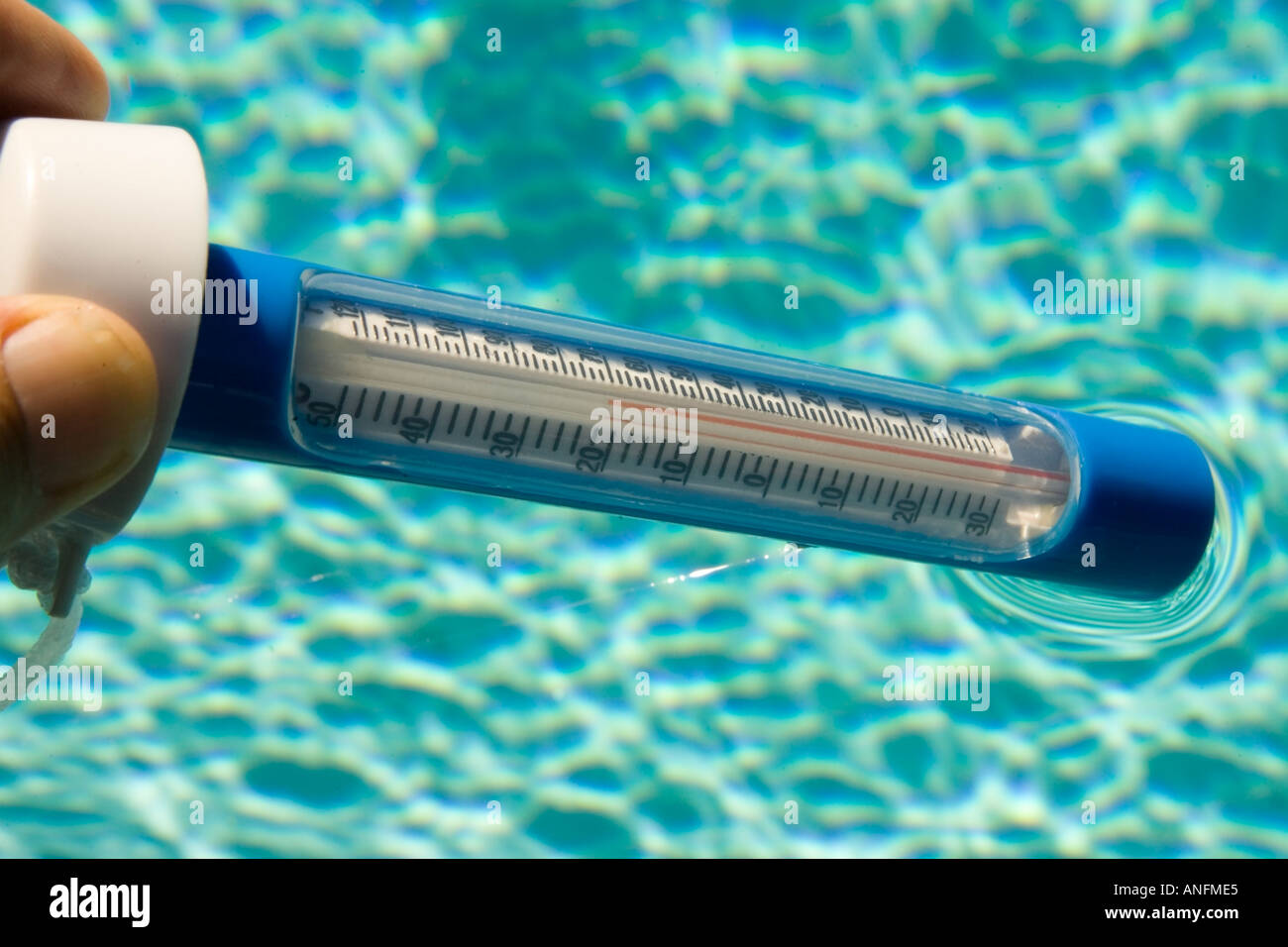 Reading a water thermometer in swimming pool, checking water temperature  Stock Photo - Alamy