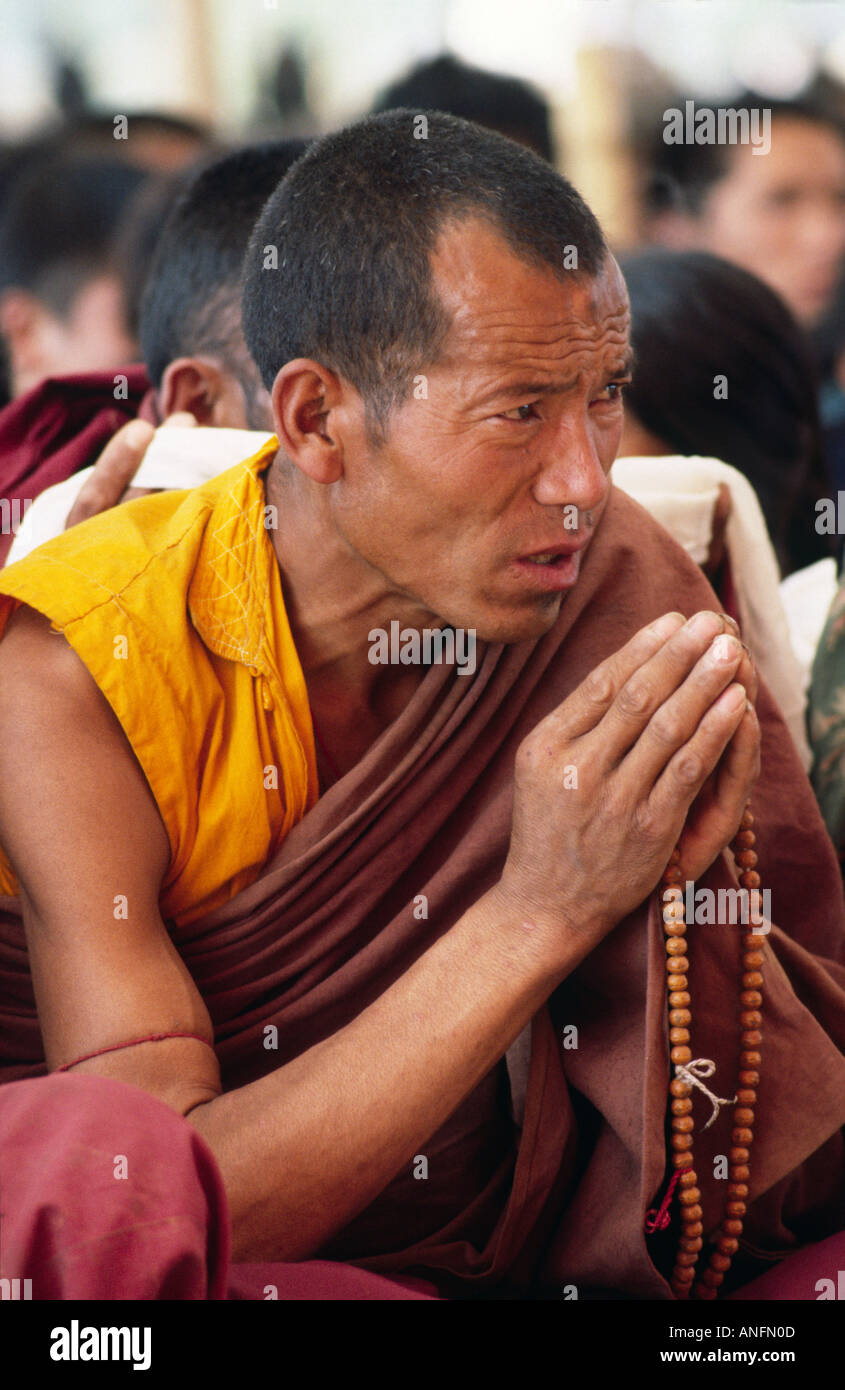 A Tibeten monk, hands in prayer, listening to the teachings of the Dalai Lama during the Kalachakra Initiation Ceremony at Bodh Gaya, Bihar, India Stock Photo