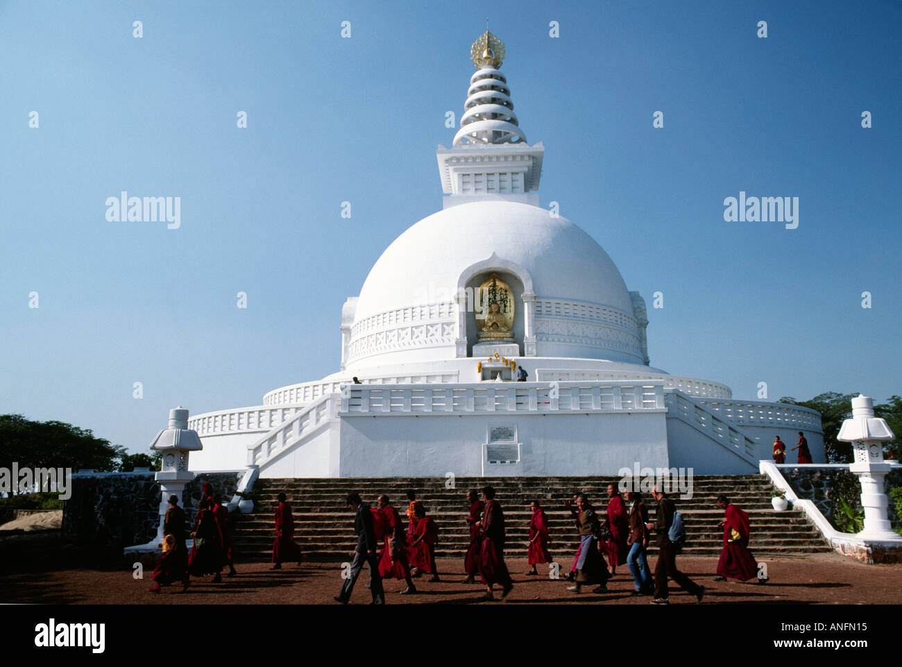 Vishwa Shanti Japanese World Peace Buddhist Stupa and Tibetan monks circumambulating, Rajgir. India Stock Photo