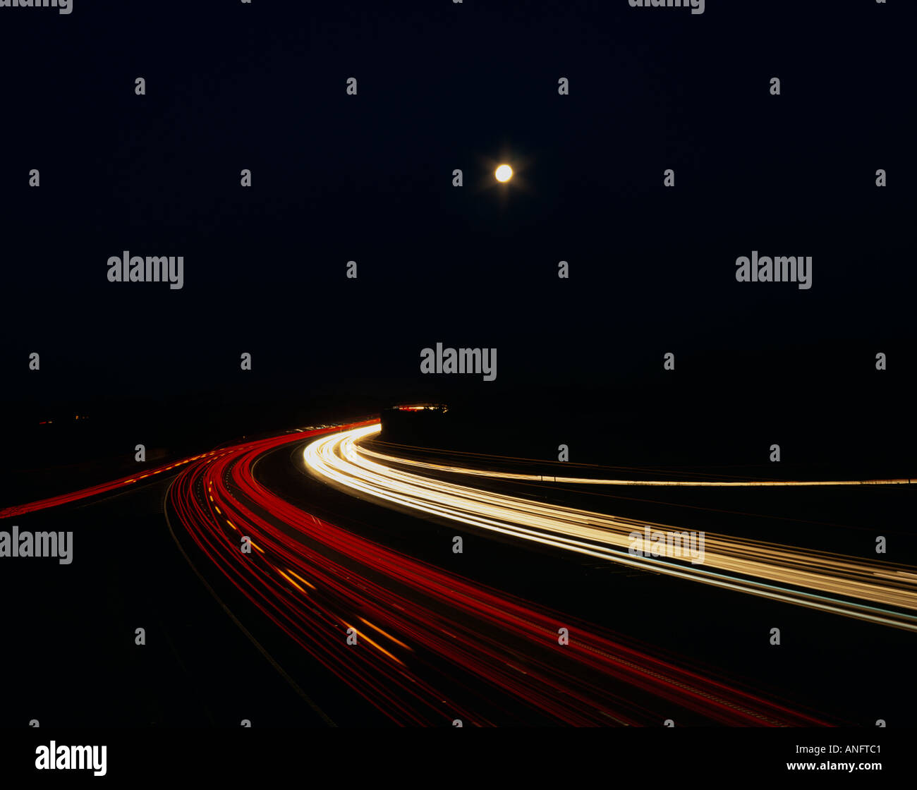 Slow Motion Traffic Under Full Moon, M56, Cheshire, UK Stock Photo